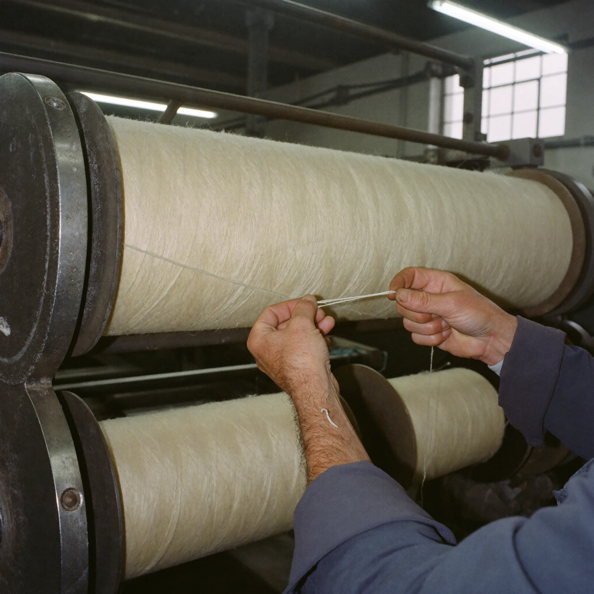 Raw natural linen fabric caught mid-undulation in a gentle wave, raw fiber texture revealed in dramatic side-light, representing signals arriving from the source before they are processed